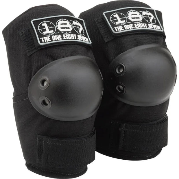 Pair of black 187 Killer Pads Standard XS elbow pads with hard-shell caps, dual rivets, wraparound straps and white logos. - Longboards USA