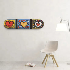 Unbranded 8.25-inch skateboard wall art with three colorful red, yellow and white hearts on bold geometric panels. - Longboards USA