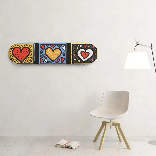 Unbranded 8.25-inch skateboard wall art with three colorful red, yellow and white hearts on bold geometric panels. - Longboards USA