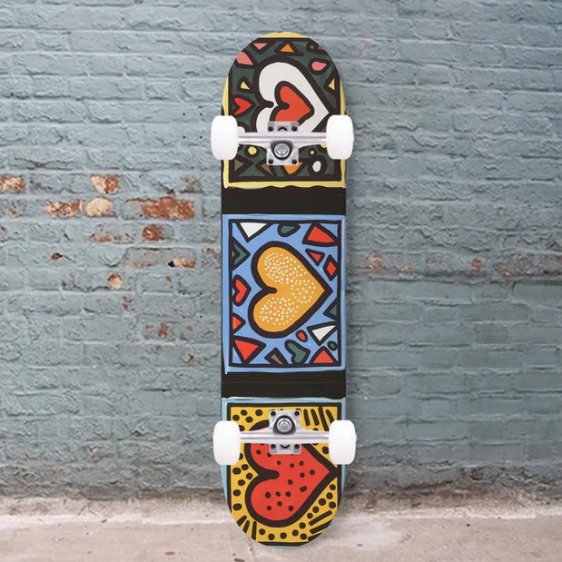 Unbranded 8.25-inch black skateboard with three colorful heart panels, white wheels, and silver trucks. - Longboards USA