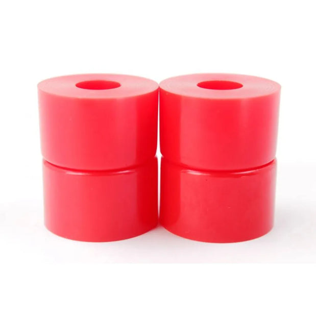 Unbranded red 90a double barrel bushings, set of four cylinders with center holes stacked in two columns. - Longboards USA