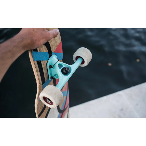 Paris V3 180mm 50º Tiffany longboard truck mounted on a wood deck, with black hardware and white wheels. - Longboards USA
