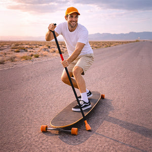 Man skatepaddleing  a longboard on a desert road with a sunset in the background