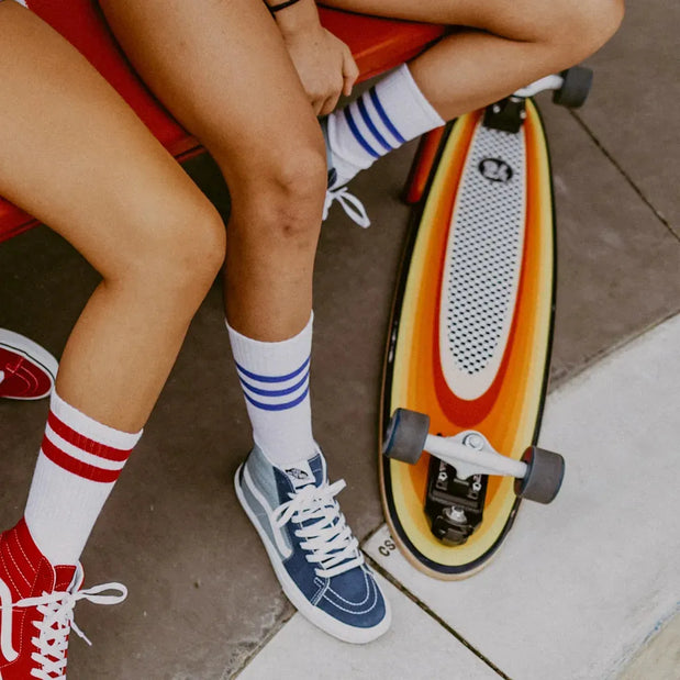 Z-Flex Surf-a-gogo Surfskate Log Roll 37-inch longboard with orange and yellow striped deck, white grip pad and gray wheels. - Longboards USA